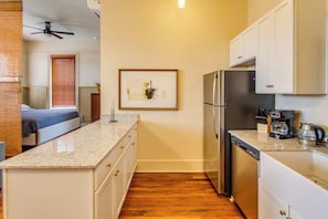A compact kitchen with a refrigerator, dishwasher, and a countertop with a coffee maker. - Walk to Shops & Restaurants! Dtwn Florence Unit (Florence)
