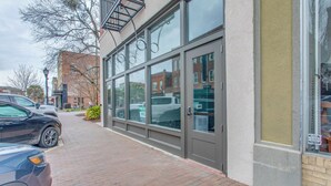 A building with large windows and a brick sidewalk. - Great for Med Professionals! Dtwn Florence Condo (Florence)