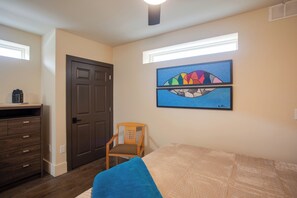 A bedroom with a bed, a chair, a dresser, and a door. - Stay in the Heart of Florence! Walkable Studio (Florence)