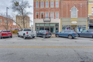 A parking lot with various vehicles, including a white GMC truck, a black SUV, and a blue sedan. - Stay in the Heart of Florence! Walkable Studio (Florence)