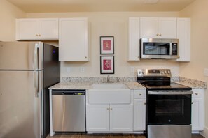 A modern kitchen with white cabinets, a stainless steel refrigerator, a dishwasher, a microwave, and an oven. - Stay in the Heart of Florence! Walkable Studio (Florence)
