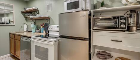 A kitchen with a microwave, toaster, refrigerator, stove, and dishwasher.