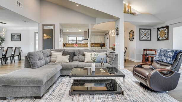 A spacious living room with a sectional sofa, a massage chair, and a coffee table. - Private 1-acre Hideaway, 2 Mi to Joe Pool Lake! (Grand Prairie)
