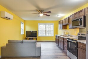 A modern kitchen with wooden cabinets, a microwave, and an oven. - Downtown Ashland & Central Park! Fresh Condo (Ashland)
