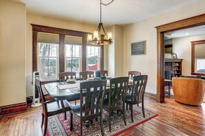 A dining room with a wooden table, six chairs, and a chandelier. - Gateway to PA Wilds: Brockport Family Home! (Brockport)