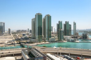 A cityscape with high-rise buildings, a marina, and a bridge. - Silkhaus 1BR Holiday-business Stay in Maryah Vista (Abu Dhabi)
