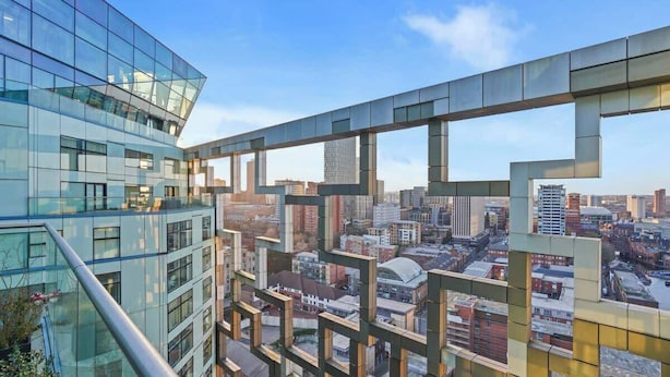 A modern building with a glass facade and a view of a cityscape. - Luxury Cube Penthouse 2BR 2BA, City Center (Birmingham)
