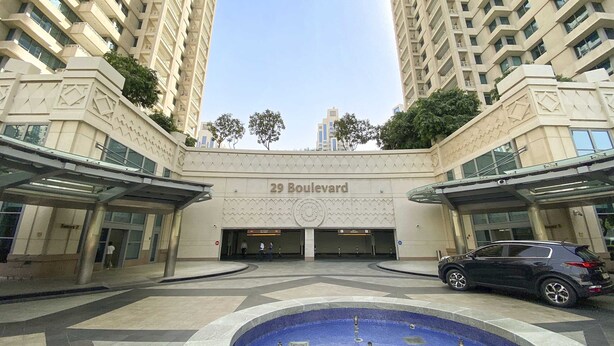 A modern building with the sign "29 Boulevard" and a central courtyard with a pool. - Silkhaus Luxury 1BR Emaar Near Burj Khalifa (Dubai)