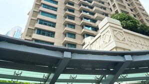 A tall, modern building with a geometric facade and multiple balconies. - Silkhaus Modern 1BR 29 Blvd Heart of Downtown (Dubai)