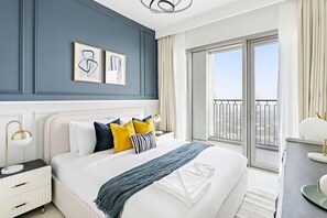 A modern hotel room with a large bed, a nightstand, a desk, and a balcony with a view. - Silkhaus Stylish 2BR Downtown Views II Emaar (Dubai)