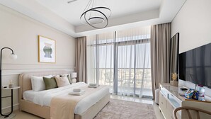 A modern hotel room with a bed, a desk, a TV, and a large window with curtains. - Silkhaus New Modern Studio Business Bay (Dubai)
