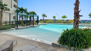 A pool area with lounge chairs, a pergola, and palm trees. - Silkhaus New High Floor Studio Aykon City (Dubai)