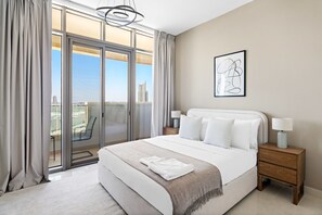 A modern hotel room with a large bed, a view of the city through floor-to-ceiling windows, a balcony, and a minimalist decor. - Silkhaus Modern 2bdr Julphar Tower Reem Island (Abu Dhabi)