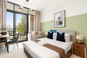 A hotel room with a bed, bedside table, chair, desk, and a view of the outside. - Silkhaus New Building Studio Near Galleria Mall (Abu Dhabi)