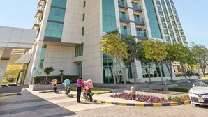 A tall, modern building with a glass facade and multiple balconies. - Silkhaus 3BR Maid Room in Marina Heights Tower (Abu Dhabi)