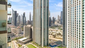 A high-rise building with a modern architectural design, featuring a grid-like facade and numerous windows. - Silkhaus Urban Chic 1bdr Heart of Downtown (Dubai)