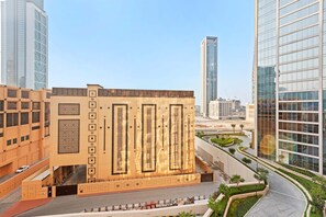 A modern building with a central courtyard, surrounded by high-rise buildings. - Downtown Apartment w Tower Pool Balcony (Dubai)
