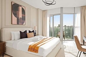 A modern hotel room with a large bed, a city view balcony, and a contemporary art piece on the wall. - Silkhaus Canal View 1BR Apartment In Reem Island (Abu Dhabi)