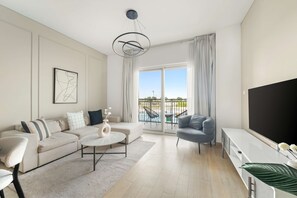 A modern living room with a sofa, coffee table, and TV stand. - Silkhaus in Water s Edge Close to Ferrari World (Abu Dhabi)