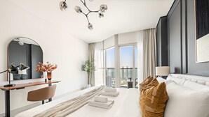 A modern hotel room with a large bed, a desk, a chair, a mirror, and a view of the city. - Silkhaus 1bdr Executive Stay in Radiant Heights (Abu Dhabi)