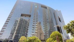 A high-rise building with a curved facade, multiple balconies, and a clear sky. - Silkhaus Modern Studio Arc Tower Reem Island (Abu Dhabi)