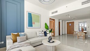 Ein modernes Wohnzimmer mit Sofa, Couchtisch und Kunstwerken.