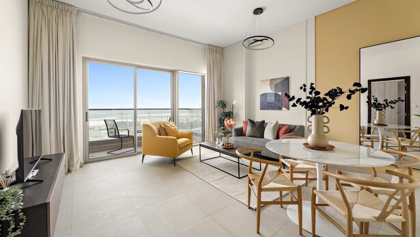 A modern living room with a large window, a sofa, a coffee table, and a dining area with chairs. - Silkhaus Signature 1bdr Najmat Al Reem Island (Abu Dhabi)