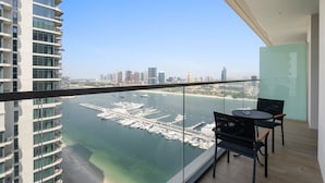 A balcony with a view of a marina and city skyline. - Silkhaus 1BR in Emaar Tower With Private Pool (Dubai)