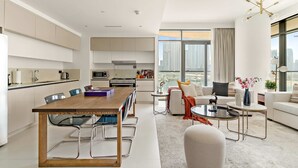 A modern apartment with a dining area, kitchen, and living space. - Silkhaus Premium Large 3BR Maid Marina Vista (Dubai)