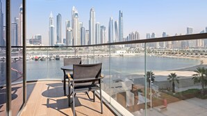 A balcony with a view of a city skyline and a body of water. - Silkhaus Premium Large 3BR Maid Marina Vista (Dubai)