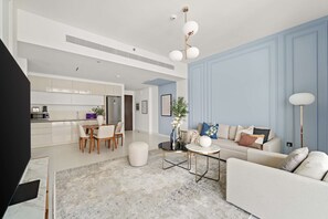 Ein modernes Wohnzimmer mit Sofa, Couchtisch und Essbereich.