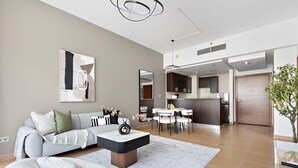 Uma sala de estar moderna com sofá, mesa de centro e área de jantar.