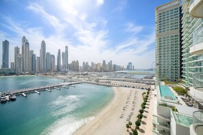 A coastal cityscape with a marina, a beach, and high-rise buildings. - Silkhaus Marina Vista Tower Full Marina View (Dubai)