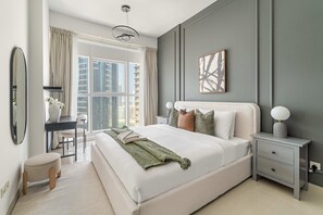 A modern bedroom with a large bed, bedside tables, a desk, and a window with curtains. - Silkhaus Chic 2BR Stay Sigma in Al Reem Island (Abu Dhabi)