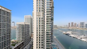 A high-rise building with multiple balconies overlooking a marina and waterfront. - Silkhaus Cozy 1bdr in Marina Vista Private Beach (Dubai)