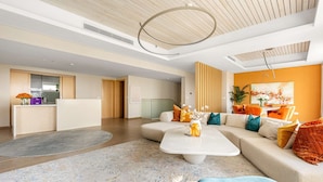 A modern living room with a sectional sofa, a coffee table, and a large rug. - Silkhaus Beach Villa Private Pool 3BR Maid (Abu Dhabi)