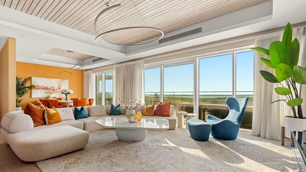 A spacious living room with a large sectional sofa, a coffee table, and a view of the outdoors. - Silkhaus Beach Villa Private Pool 3BR Maid (Abu Dhabi)