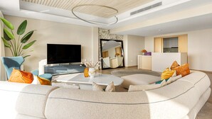 A modern living room with a large sofa, a coffee table, and a TV. - Silkhaus Beach Villa Private Pool 3BR Maid (Abu Dhabi)