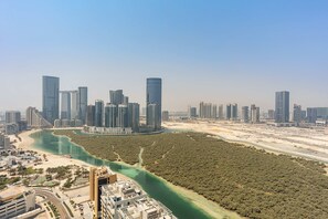 A coastal cityscape with high-rise buildings, a river, and a beach. - Silkhaus Sea View 2bdr Retreat Oceanscape (Abu Dhabi)