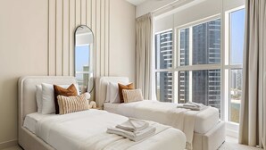 A hotel room with two beds, a large window with a city view, and a mirror on the wall. - Silkhaus Premium 2bdr Stay in Al Reem Island (Abu Dhabi)