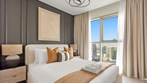 A modern hotel room with a large bed, a nightstand, a lamp, and a city view through the window. - Silkhaus Lavish 3bdr Stay in Radiant Boulevard (Abu Dhabi)