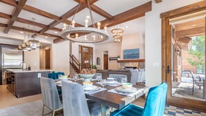 A dining area with a wooden ceiling, a fireplace, and a view of the outdoors. - Schaffer's Mill - Chaparral 4 Bedroom Home (Truckee)