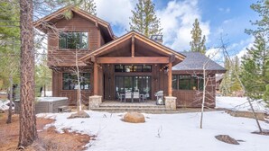A wooden cabin with a front porch, large windows, and a stone fireplace. - Schaffer's Mill - Chaparral 4 Bedroom Home (Truckee)