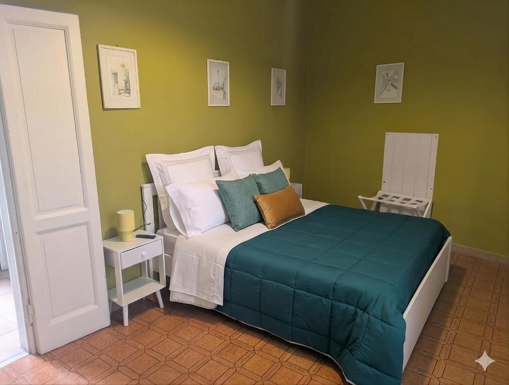 Une chambre à coucher avec un lit, une table de chevet et une chaise.