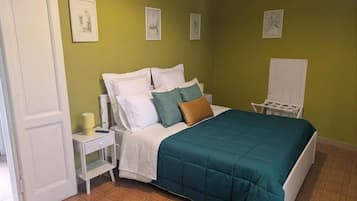 Ein Schlafzimmer mit Bett, Nachttisch und Stuhl.