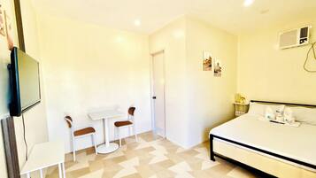 Desk, laptop workspace, blackout drapes, iron/ironing board