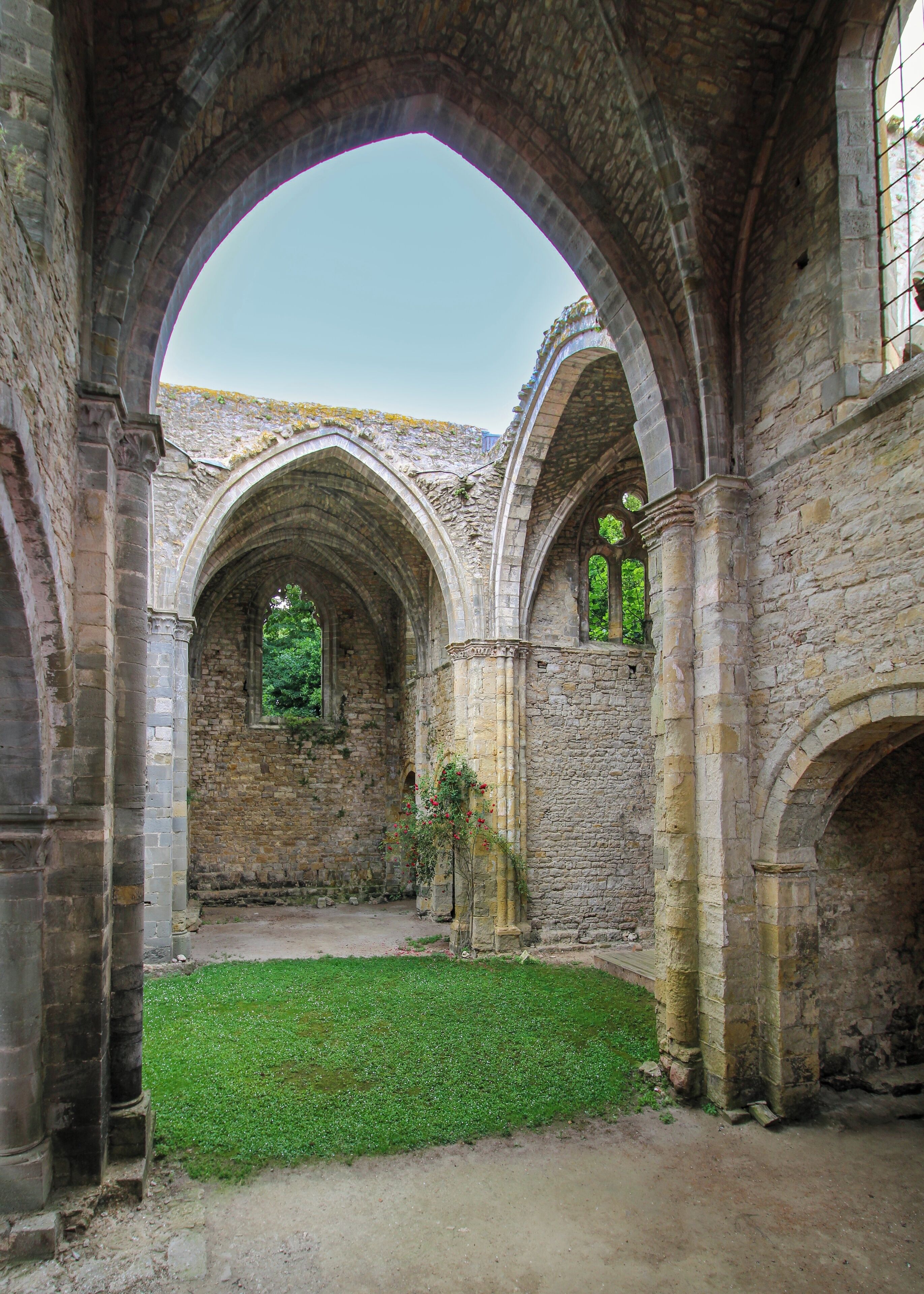 An interior of a historic building with stone arches and a central courtyard.