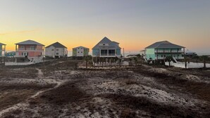 A row of beach houses with a view of the ocean at sunset. - Doodle Dunes: New! Private Pool + Dog Friendly (Gulf Shores)