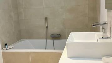 Shower, hair dryer, soap, toilet paper