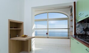 A kitchen with a large window, a wooden countertop, and a view of the sea. - Villa Lisuccia - Two Stunning Independent units for your Vacation, with a view (Campania)